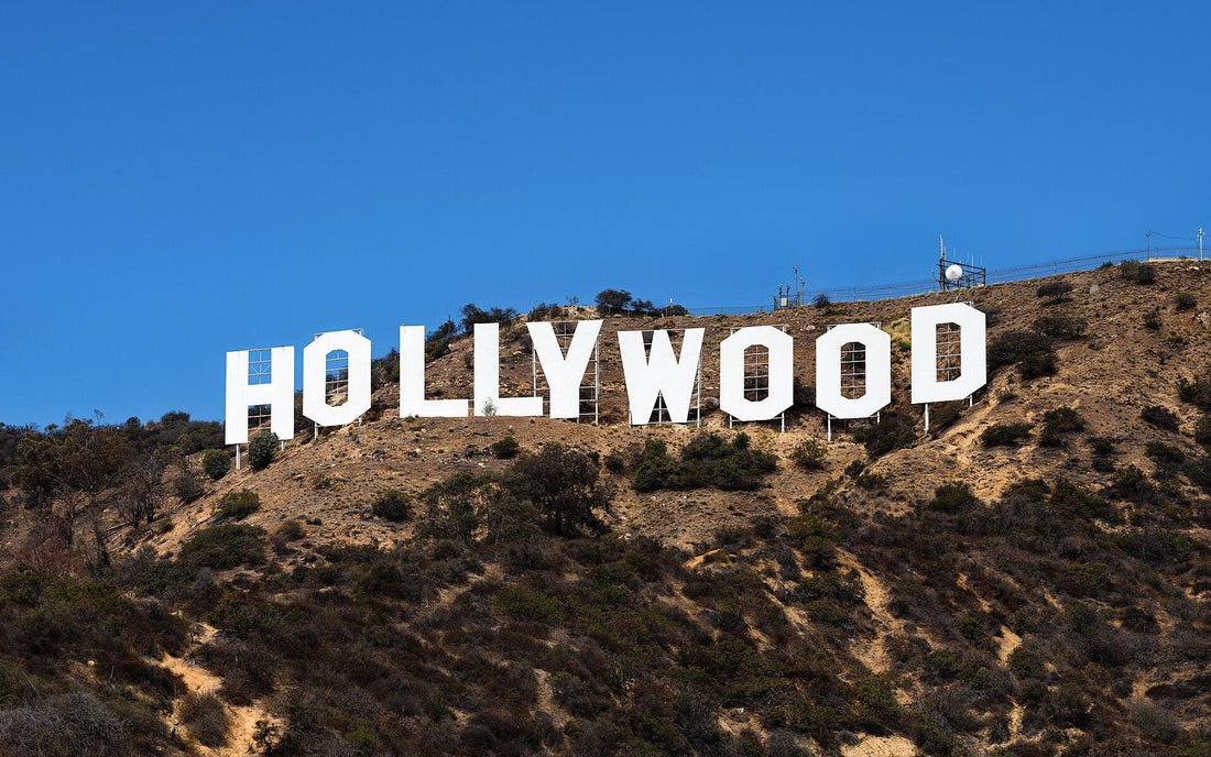 Iconic Hollywood sign on a sunny day, symbolizing the glamour of movies and film industry, perfect backdrop for showcasing luxurious diamond and gold engagement rings